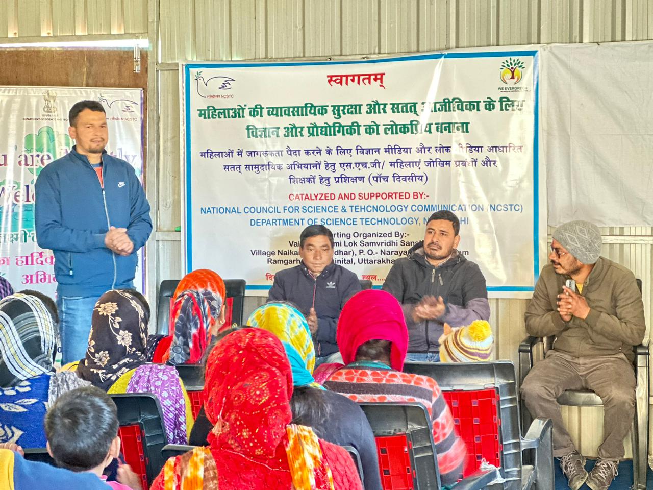 Women listen to speakers during a community discussion about livelihood opportunities.